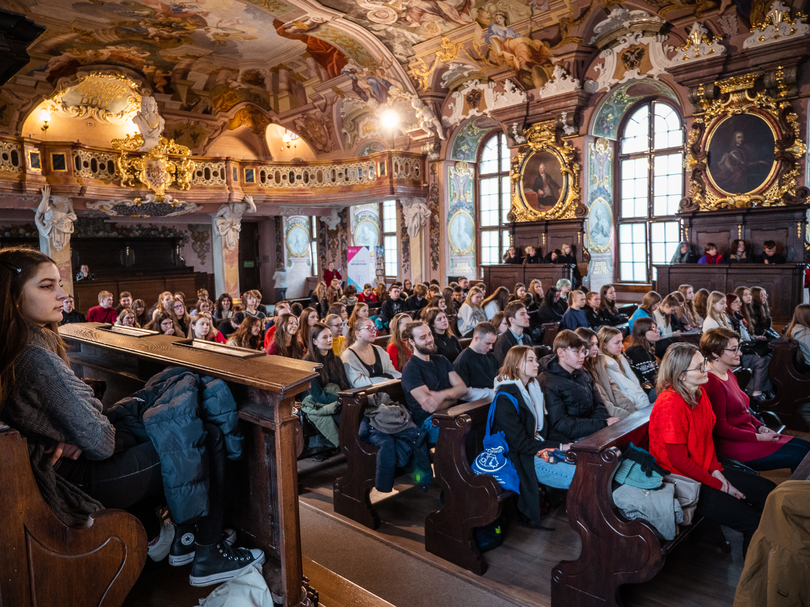 zabytkowa historyczna aula pełna ludzi