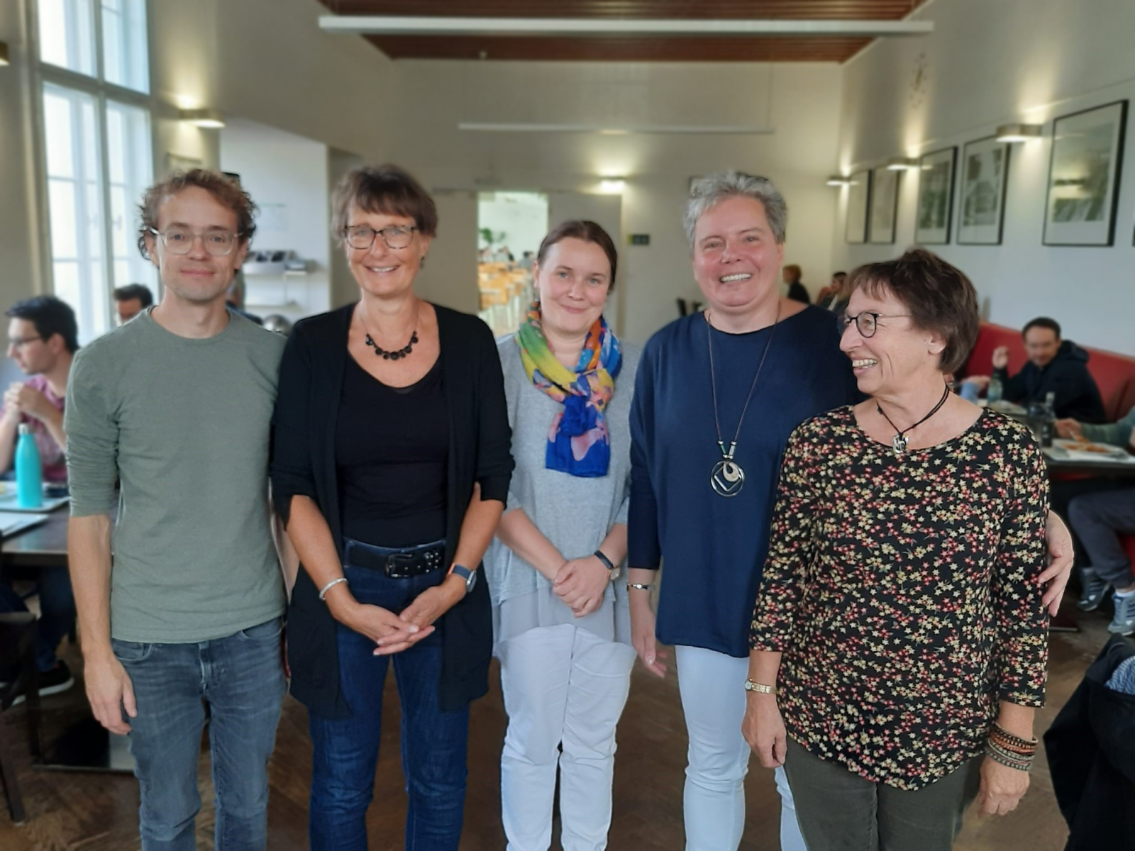 pięć stojących osób w średnim wieku