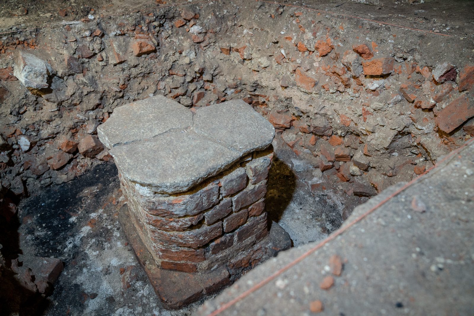 badania archeologiczne w piwnicy instytutu historycznego, kamienne fragmenty starych budynku